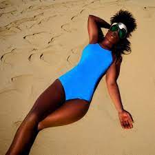 beautiful young ebony woman sunbathing at the beach on | Stable Diffusion