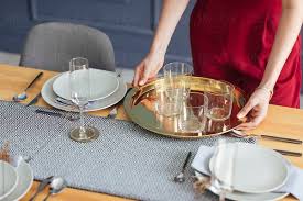 Place them in the middle of the dinner plate. Woman Setting Up Dinner Table By Lumina Decor Dinner