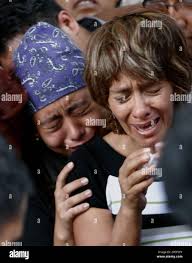 Silvia Calvo, right, the wife of Oaxacan teacher Jaime Rene Calvo and their  daughter Judith, left, cry during his funeral service in Oaxaca, Mexico,  Saturday, Oct. 7, 2006. Calvo was killed last