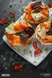 Salmon breakfast pizza recipe | smoked salmon breakfast. Smoked Salmon Bagel Toasts With Soft Cheese Cucumber Ribbons And Beetroot And Dill Cress Salad Image Stock Photo 252229735