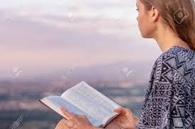 Christian Worship And Praise. A Young Woman Is Reading The Bible ...