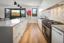Explore price estimates to install a new kitchen island, replace an existing or add waterfall feature. Sleek Modern Kitchen With Stone Island Bench And Feature Splash Back Tiles Modern Melbourne By Rycon Building Group Houzz