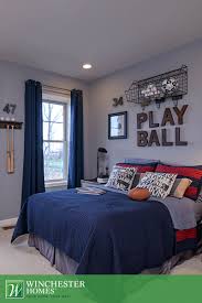 Elevate the twin bed for extra storage. With Floor Length Blue Curtains And Red And Navy Bedding This Newport Model Bedroom Is The Perfect Backd Blue Bedroom Decor Boy Room Themes Boy Bedroom Design