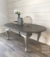 An Oval Table Takes On A Farmhouse Style Look With A Distressed Weathered Wood Finish Wood Furniture Design Distressed Coffee Table Home Decor