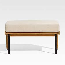 These have the same beige linen material with silver nail heads but no wood trim at the bottom. Outdoor Ottomans For Patios Decks Crate And Barrel