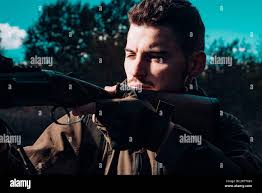Close up snipers carbine at the outdoor hunting. Hunter with shotgun gun