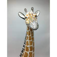 This adorable spotted giraffe will watch you from under its long eyelashes as it hangs over your work. Ceramic Giraffe Figurine