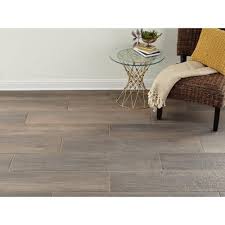 The color is emphasized by a beautiful shape that just note that all the tiles are the same color and the same gradient of grey. Carson Ridge Brown Wood Plank Porcelain Tile Wood Planks Brown Wood Porcelain Tile
