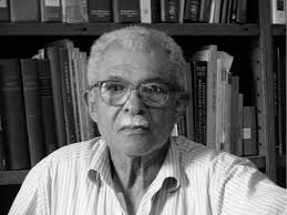 Daniel Vital in his office, with part of his extensive library behind...