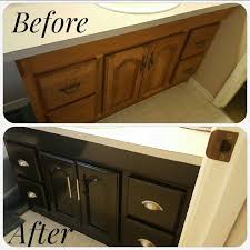 White kitchen cabinets, accented with antique brass hardware and contrasting ebony stained oak wood floors, flank a blue la cornue cornufé 90 albertine range fixed against white subway backsplash tiles and beneath a gold and blue range hood mounted between stacked white cabinets. Cabinet Redo Using Rustoleum Ebony Stain Redo Cabinets Home Kitchens Kitchen Colors