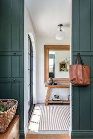 Angela Wheeler Design Mudroom With Dark Green Panelled Walls Loads Of Hooks Leather Bench Seat Small Entryways Dark Interiors Entryway