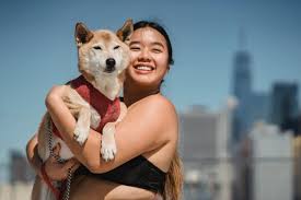 Happy Asian woman cuddling cute dog · Free Stock Photo