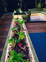 In this article, we will teach you how to create wonderful garden lighting ideas that vary from candles, leds, lanterns, chandeliers, wall lights, pendants, and more that will match and fit your landscape design. Garden Lighting Using Led S In Sleeper Beds Garden Path Lighting Backyard Landscaping Designs Garden Shed Greenhouse Ideas