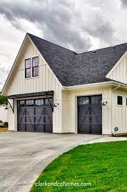 The Heartland On The Exterior Of This Modern Farmhouse Home Carriage Style Garage Do Carriage Style Garage Doors Garage Door Design Modern Farmhouse Exterior
