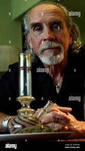 Lonnie Painter, 65, who uses marijuana for medicinal purposes and is the  director of a group known as Laguna Woods for Medical Cannabis, poses with  his medicinal herb and bong at his