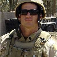 In an undated file photo provided by the U.S. Navy, Master-At-Arms 2nd  Class (SEAL) Michael A. Monsoor poses for a photo with members of his SEAL  team during Operation Iraqi Freedom. -