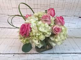 Luxurious crème roses and pure white lilies paint a peaceful picture inside a sapphire blue cube. St Louis Wedding Flowers Hydrangea And Roses Centerpieces In St Louis Mo Irene S Floral Design