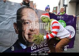 A person dressed as the Grinch as UNISON health workers deliver a message  from thousands of members, who have not received a pay rise, to the  Secretary of State Chris Heaton Harris,