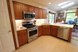 Cherry kitchen cabinets with white quartz countertop. Cherry Kitchen Cabinets With Corian Countertops Broadview Heights Oh Traditional Kitchen Cleveland By Cabinet S Top Houzz