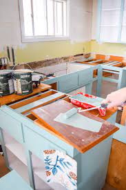Paying a professional to refinish or reface kitchen cabinets can be expensive. How To Paint Your Plywood Kitchen Cabinets Pmq For Two