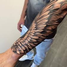 Flugel Tattoo Designs Mann Mit Realitischer Tatowierung Am Unterarm Schwarz Graues Tattoo Am Arm Flugel Tattoo Tattoo Designs Mannliche Tattoo Armel