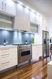 This kitchen designer used a light grey shaker cabinet design for a subtle pop of contrast against the shimmery white herringbone backsplash. Modern Kitchen Cabinets White Decorkeun