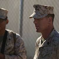 Gunnery Sgt. Kevin D. Pirtle (right) helps Marines