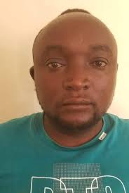 A.W. Langkilde and Brothers service station worker. Look no shoes kalofae.  Anyone recognize him? Photo, 1956.