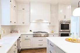 all white kitchen with bronze harwdare