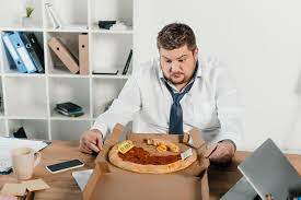 5,354 likes · 5 talking about this · 272 were here. Ubergewichtiger Geschaftsmann Schaut Sich Im Buro Pizza An Lizenzfreies Foto Und Stockbild