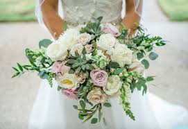 Flower arrangements tend to dominant weddings, whether it's for decor or part of the bouquets the bride and bridesmaids are carrying down the aisle. Bridal Bouquet Garden Look Large By Woods Flowers