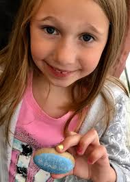 Woman poses in front of shark mural