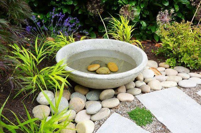 Bird bath with rocks in it