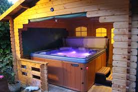 There is a queen size bed in the loft and a sofa sleeper in the living room. Log Cabins England With A Hot Tub Cabin