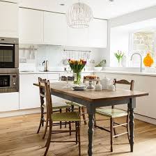 white gloss kitchen with wooden table
