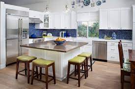 A black and white kitchen by studio surface, an interior design firm out of del mar, california gets a functional lift from a narrow, stainless steel chef's table.the handy piece of furniture makes an excellent kitchen island at a fraction of the cost. Creative Square Kitchen Island With Seating Square Kitchen Kitchen Island With Seating Kitchen Island Table