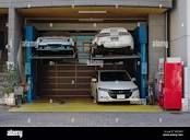 Tokyo street garage with wrecked sport cars Stock Photo - Alamy