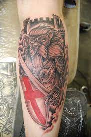 A beautiful watercolor lion tattoo on arm. Lion England England Tattoo Mens Shoulder Tattoo Tribal Tattoos