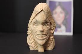 Carving a female singer figurine from wood