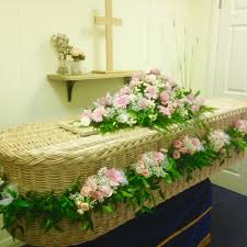 Our hand crafted wicker basket casket features classic basket weaving willow (buff willow) woven in tandem with natural green willow and uk native timber. Willow Coffin With Flower Garland