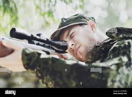 Man aiming sniper rifle hi-res stock photography and images