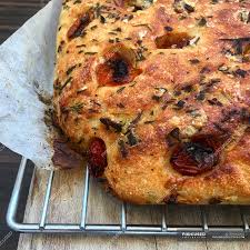 The dough is rolled out, placed into the sheet pan and then brushed rosemary focaccia is also quite popular and sage is another herb that is often used instead of rosemary. Loaf Of Tomato Focaccia Bread Closeup View Cooked Food Styling Stock Photo 239000352