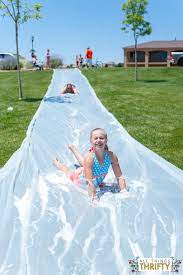 41 Backyard Diys That Will Make Yours The Coolest House On The Block Water Slides Backyard Slip N Slide Giant Slip And Slide