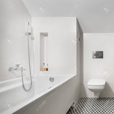 Check spelling or type a new query. White Bathroom With Bathtub Toilet And Black And White Mosaic Floor Tiles Stock Photo Picture And Royalty Free Image Image 123514827