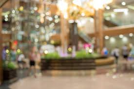 This large shopping center is nearly an entire city block and boasts a diverse array of shops. Shopping Mall Blurred Background Blurred Background Background Microstock Photography