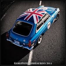 the backside of a 1971 mgb gt tricked out with a painted uk flag and racing number british sports cars british cars retro cars