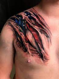 Ripped skin american flag tattoos on shoulder. Tattoo Skin Rips