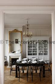 This black lacquer oriental dining table is hand painted and inlaid with mother of pearl. Jean Marc Palisse The Interior Archive