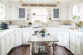 Speed the aging process by dipping the tips of a paintbrush in a color lighter than the cabinets, dabbing the excess onto a cloth until the brush is almost dry and lightly grazing the surface of detail trim, corners, or seams. How To Make Old Cabinets Look New With Paint