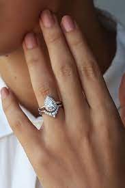 This Would Be Perfect If The Engagement Stone Was Round I Really Like Th Pear Shaped Diamond Engagement Rings Diamond Engagement Rings Unique Engagement Rings